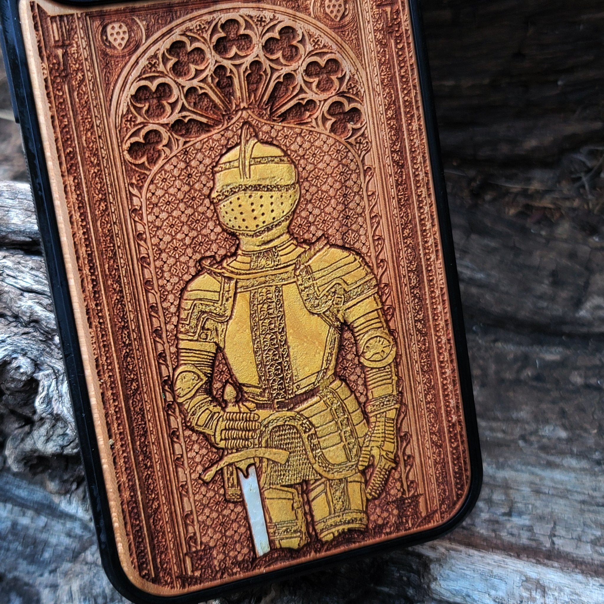 Wooden phone case featuring a medieval knight in armor, hand-painted with gold accents, laser-engraved on cherrywood. Compatible with iPhone -11 Pro Max, Galaxy S-S20. Historical and artistic phone case.