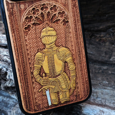 Wooden phone case featuring a medieval knight in armor, hand-painted with gold accents, laser-engraved on cherrywood. Compatible with iPhone -11 Pro Max, Galaxy S-S20. Historical and artistic phone case.
