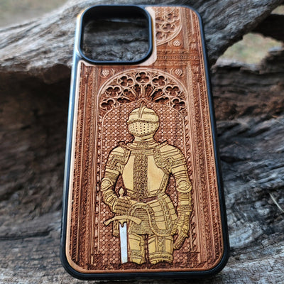 Wooden phone case featuring a medieval knight in armor, hand-painted with gold accents, laser-engraved on cherrywood. Compatible with iPhone -11 Pro Max, Galaxy S-S20. Historical and artistic phone case.