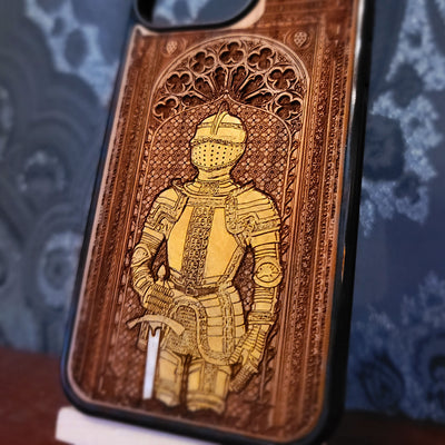 Deep laser engraved wooden phone case featuring a medieval knight in detailed armor holding a sword on natural wood for iPhone and Samsung Galaxy models.