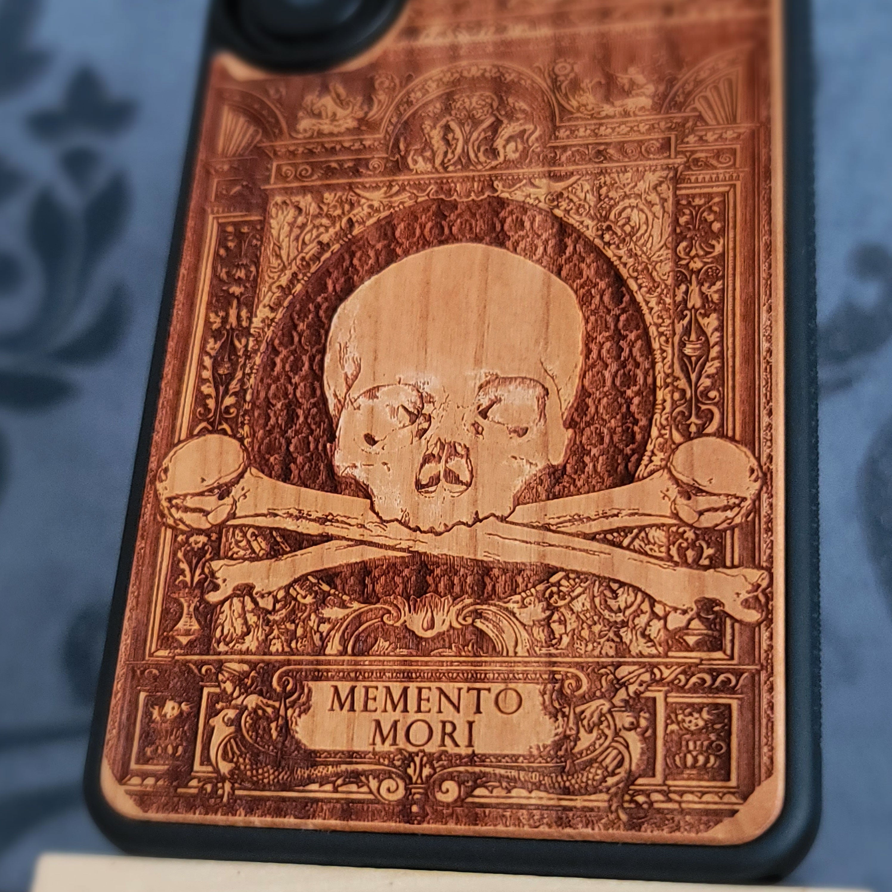 Laser-engraved Memento Mori wood phone case for iPhone and Galaxy – skull and hourglass symbolism, dark art design.