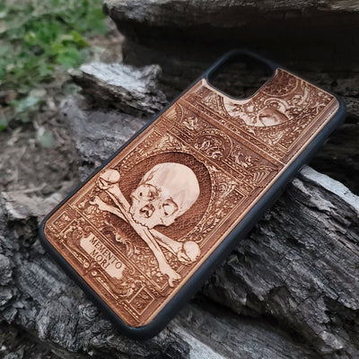 Wooden Memento Mori II phone case with intricate gothic skull design, compatible with iPhone , iPhone 15, Galaxy S, Galaxy S24, and other models. Ideal for horror and gothic art lovers.