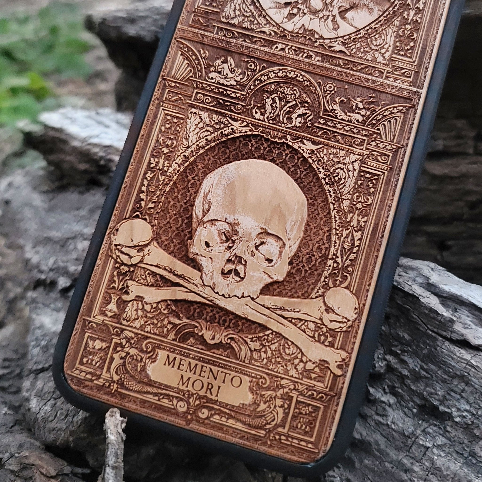 Wooden Memento Mori II phone case with intricate gothic skull design, compatible with iPhone , iPhone 15, Galaxy S, Galaxy S24, and other models. Ideal for horror and gothic art lovers.