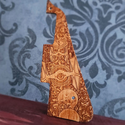 Wooden guitar pickguard with futuristic starfighters and ornate galactic laser engraved design