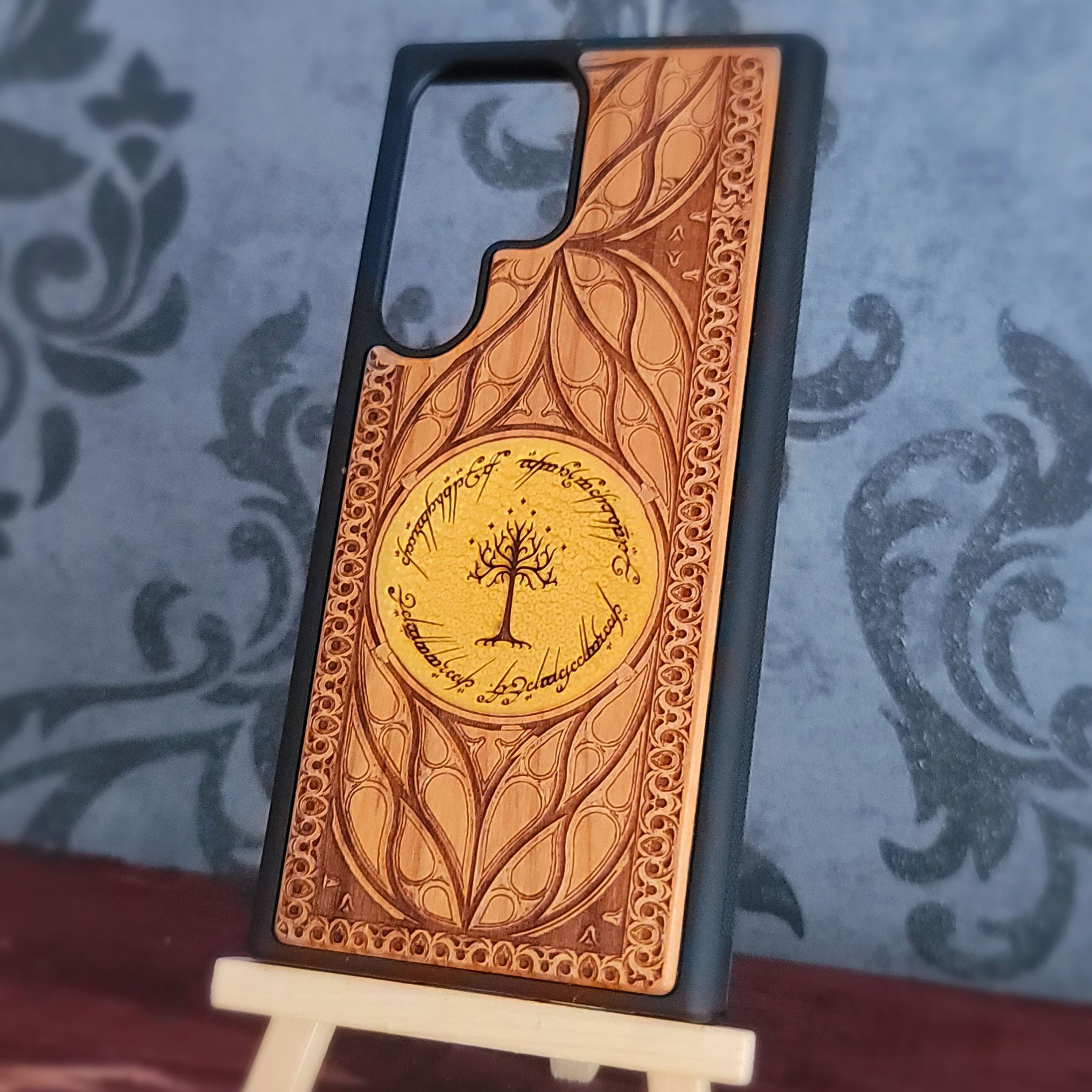 Hand-painted LOTR wooden phone case showing detailed engraved artwork
