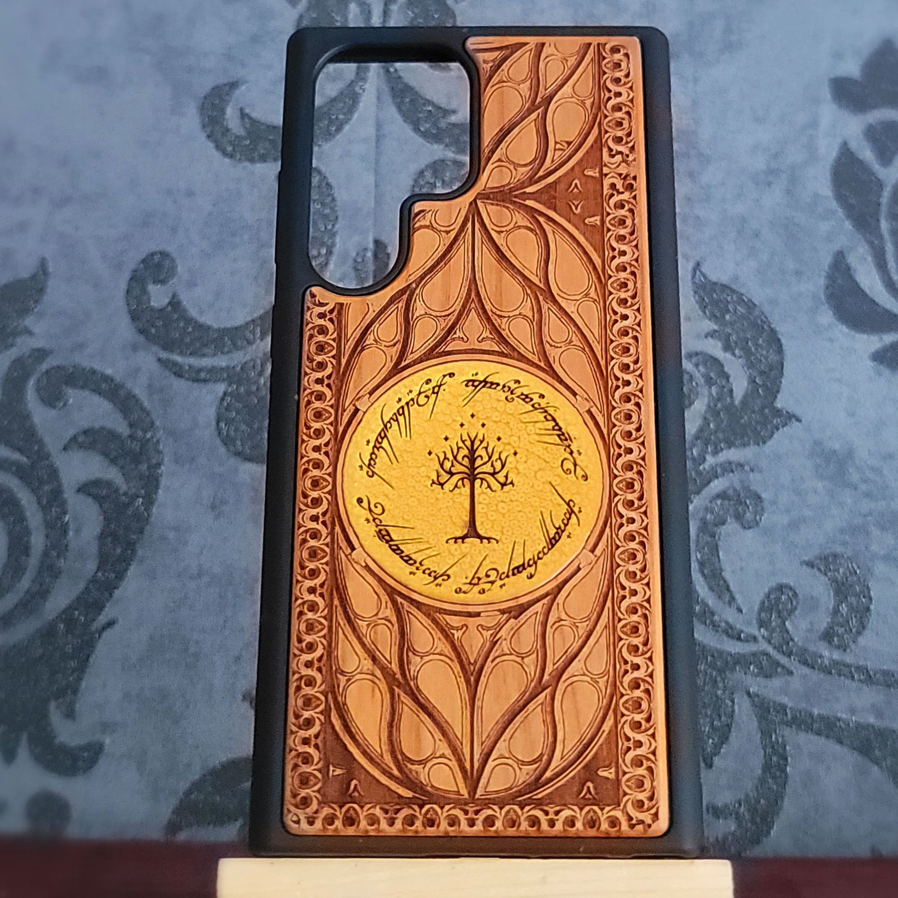 Close-up of hand-painted Lord of the Rings design on wooden phone case
