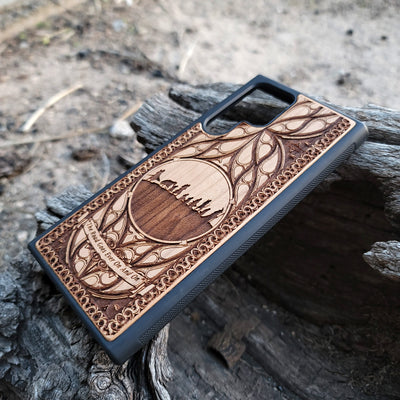 Lord of the Rings wood phone case featuring the Fellowship of the Ring silhouette, intricate Elvish-inspired patterns, and the engraved quote 'The Road Goes Ever On And On.' Laser-engraved for detailed artistry and durability. Compatible with iPhone , 15, 14, 13, 12, 11, Pro Max, Mini, and Samsung Galaxy S, S24, S23, S22, S21, S20 Ultra, Plus, Note 20. A unique and protective accessory for Tolkien fans.