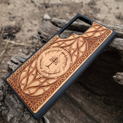 "Lord of the Rings White Tree of Gondor wood phone case, laser-engraved with intricate Elvish script and decorative patterns. This durable and protective case is compatible with iPhone , 15, 14, 13, 12, 11, Pro Max, Mini, and Samsung Galaxy S, S24, S23, S22, S21, S20 Ultra, Plus, Note 20. Elegant, slim, and perfect for Tolkien fans seeking a unique phone accessory."
