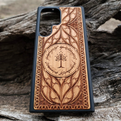 "Lord of the Rings White Tree of Gondor wood phone case, laser-engraved with intricate Elvish script and decorative patterns. This durable and protective case is compatible with iPhone , 15, 14, 13, 12, 11, Pro Max, Mini, and Samsung Galaxy S, S24, S23, S22, S21, S20 Ultra, Plus, Note 20. Elegant, slim, and perfect for Tolkien fans seeking a unique phone accessory."