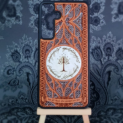 Phone case with intricate design and tree of Gondor emblem on a decorative background