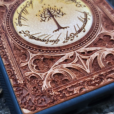 Lord of the Rings Gothic wood phone case featuring intricate laser-engraved designs inspired by Tolkien's Middle-Earth. The design includes Elvish script and Gothic elements, creating a dramatic, elegant look. Compatible with iPhone , 15, 14, 13, 12, 11 Pro Max Mini and Samsung Galaxy S, S24, S23, S22, S21, S20 Ultra, Plus, and Note 20. A stylish, durable, and unique accessory for LOTR fans.
