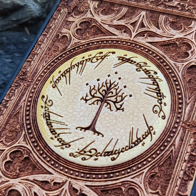 Lord of the Rings Gothic wood phone case featuring intricate laser-engraved designs inspired by Tolkien's Middle-Earth. The design includes Elvish script and Gothic elements, creating a dramatic, elegant look. Compatible with iPhone , 15, 14, 13, 12, 11 Pro Max Mini and Samsung Galaxy S, S24, S23, S22, S21, S20 Ultra, Plus, and Note 20. A stylish, durable, and unique accessory for LOTR fans.