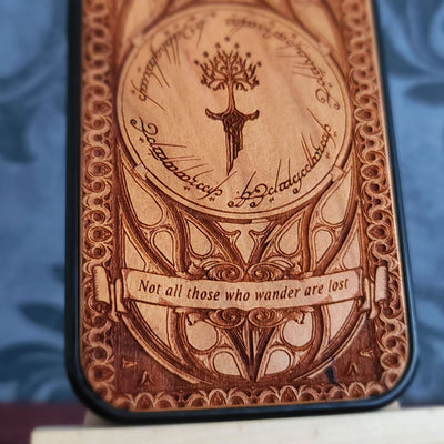 Lord of the Rings wood phone case featuring the White Tree of Gondor, Elvish script, and the iconic quote 'Not all those who wander are lost.' Laser-engraved for intricate detailing and crafted for durability, this case is compatible with iPhone and Samsung Galaxy 