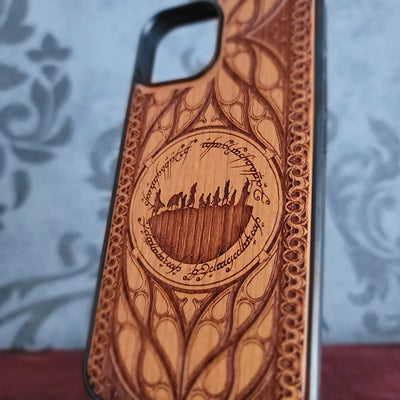 Lord of the Rings wood phone case featuring the Fellowship of the Ring silhouette surrounded by Elvish script and intricate, elegant patterns. 