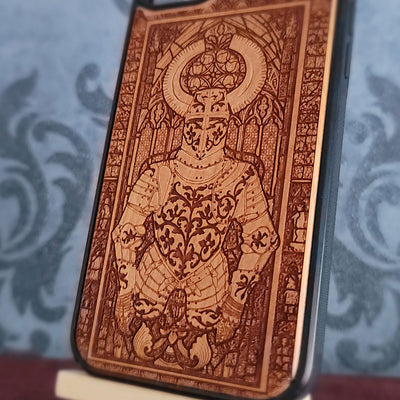 A close-up of a phone case featuring an intricate laser-engraved knight in armor design