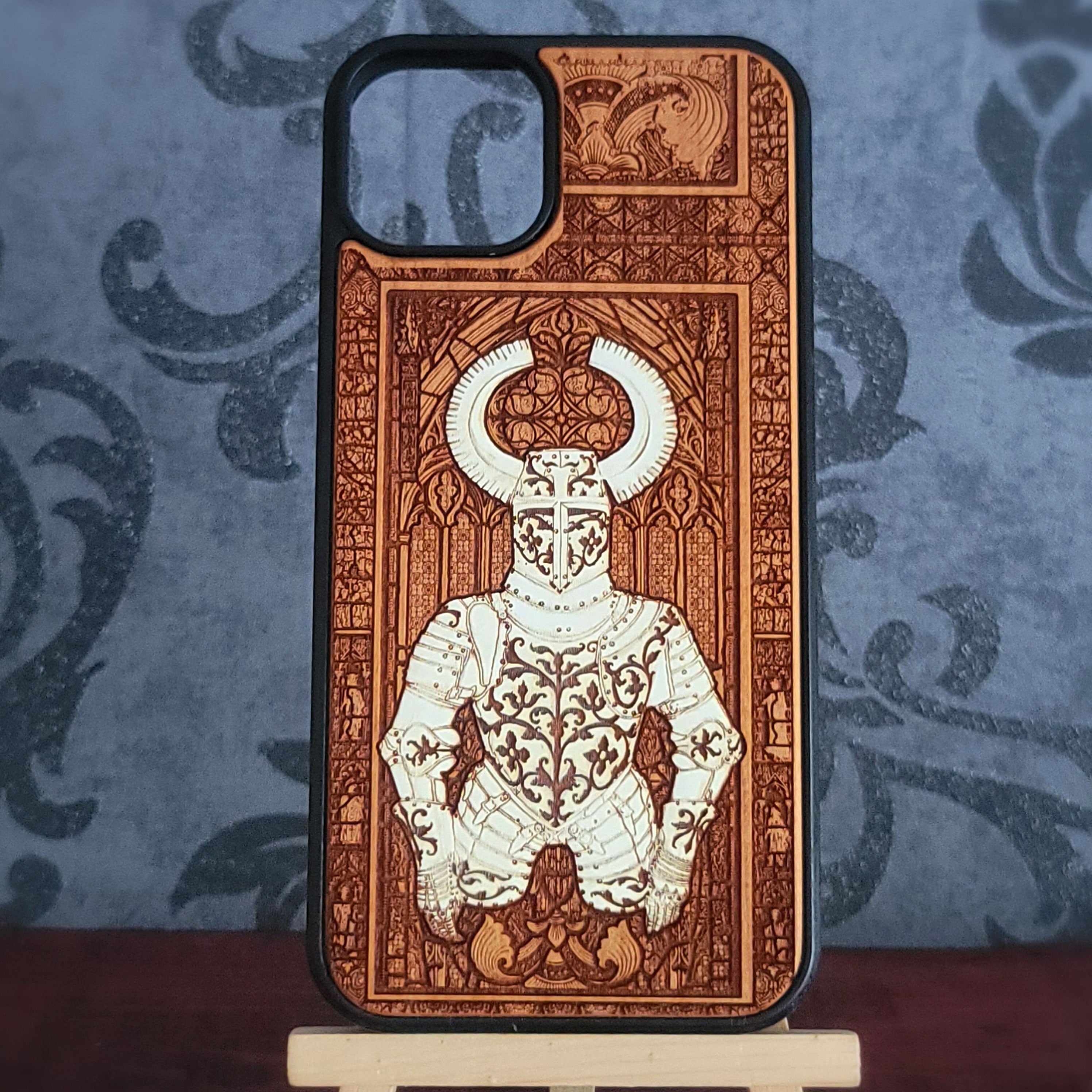 A wooden phone case featuring a detailed laser-engraved illustration of a horned knight in armor,