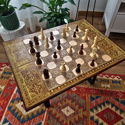 Close-up of detailed laser engraving on medieval themed wooden chessboard showing intricate artwork
