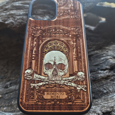 Hand-painted Memento Mori wooden phone case featuring a laser-engraved skull and bones design on cherrywood. Compatible with iPhone -11 Pro Max and Galaxy S-S20.