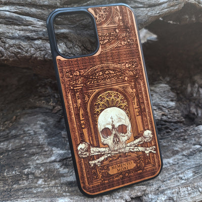 Hand-painted Memento Mori wooden phone case featuring a laser-engraved skull and bones design on cherrywood. Compatible with iPhone -11 Pro Max and Galaxy S-S20.