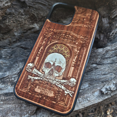 Hand-painted Memento Mori wooden phone case featuring a laser-engraved skull and bones design on cherrywood. Compatible with iPhone -11 Pro Max and Galaxy S-S20.