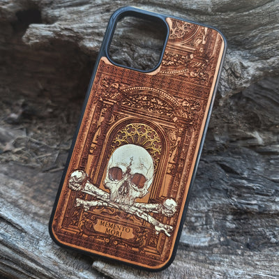 Hand-painted Memento Mori wooden phone case featuring a laser-engraved skull and bones design on cherrywood. Compatible with iPhone -11 Pro Max and Galaxy S-S20.