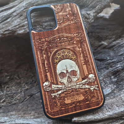 Hand-painted Memento Mori wooden phone case featuring a laser-engraved skull and bones design on cherrywood. Compatible with iPhone -11 Pro Max and Galaxy S-S20.