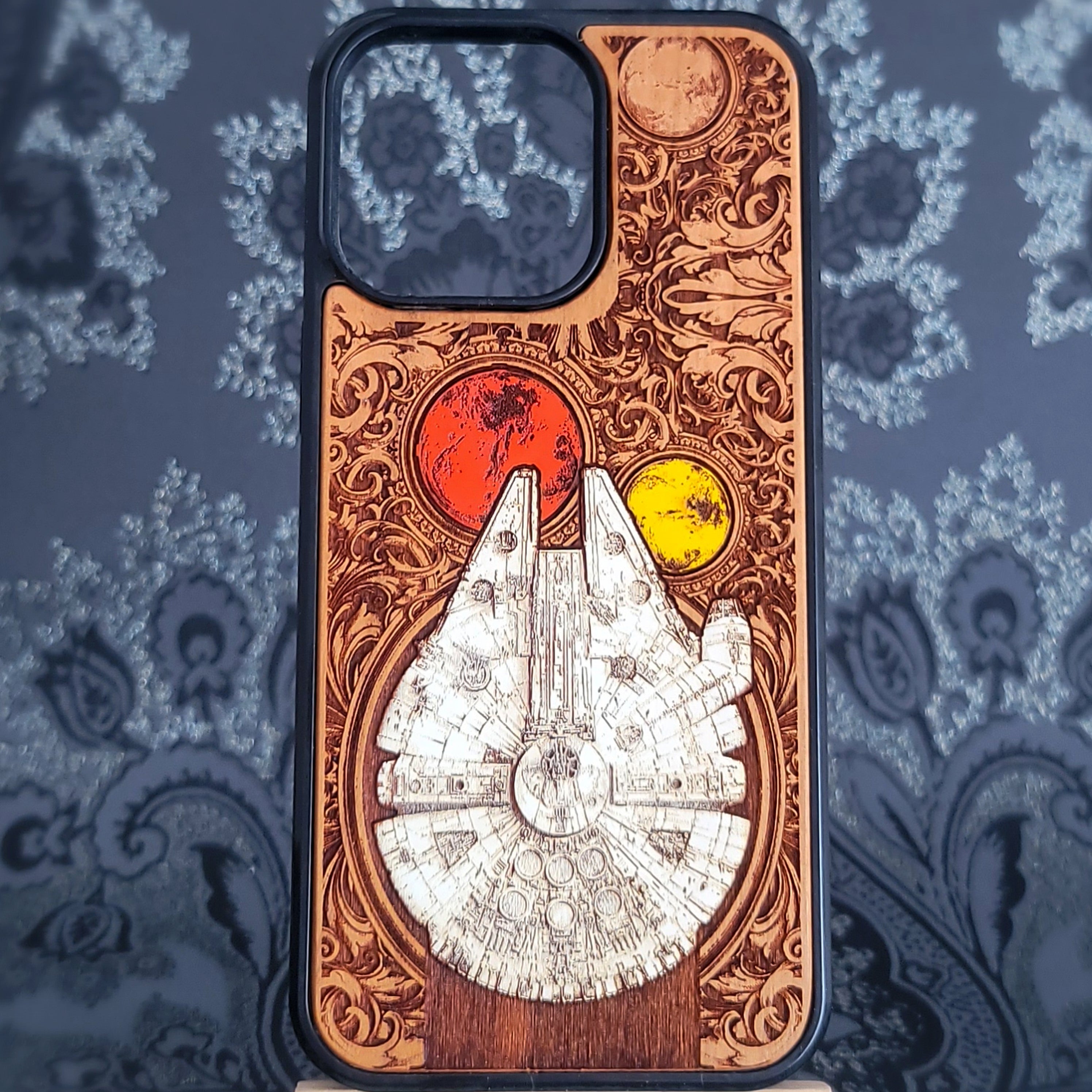 Deep laser engraved wooden phone case featuring a detailed sci-fi smuggler spaceship inspired by classic space adventure movies for iPhone and Samsung Galaxy models.