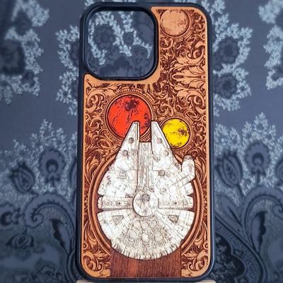 Deep laser engraved wooden phone case featuring a detailed sci-fi smuggler spaceship inspired by classic space adventure movies for iPhone and Samsung Galaxy models.