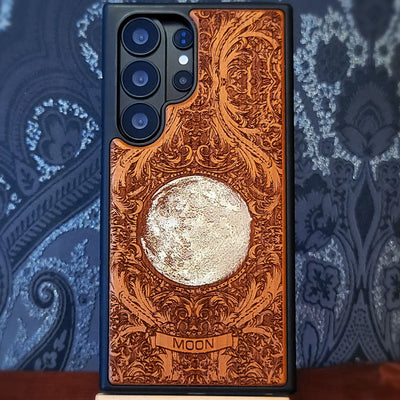 Hand painted silver moon wooden phone case with deep laser engraved celestial artwork for iPhone and Samsung Galaxy models.