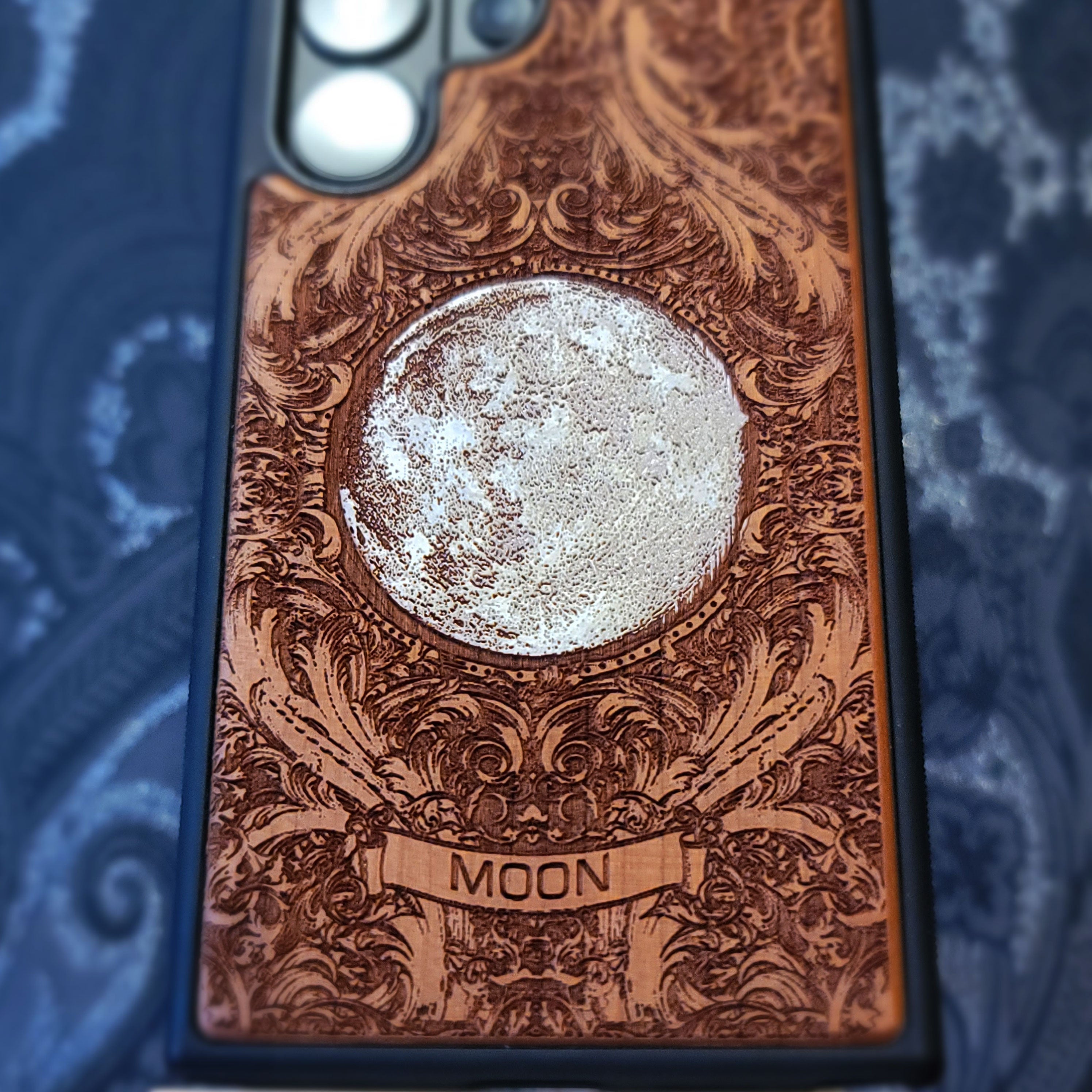 Hand painted silver moon wooden phone case with deep laser engraved celestial artwork for iPhone and Samsung Galaxy models.