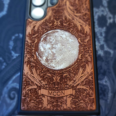 Hand painted silver moon wooden phone case with deep laser engraved celestial artwork for iPhone and Samsung Galaxy models.