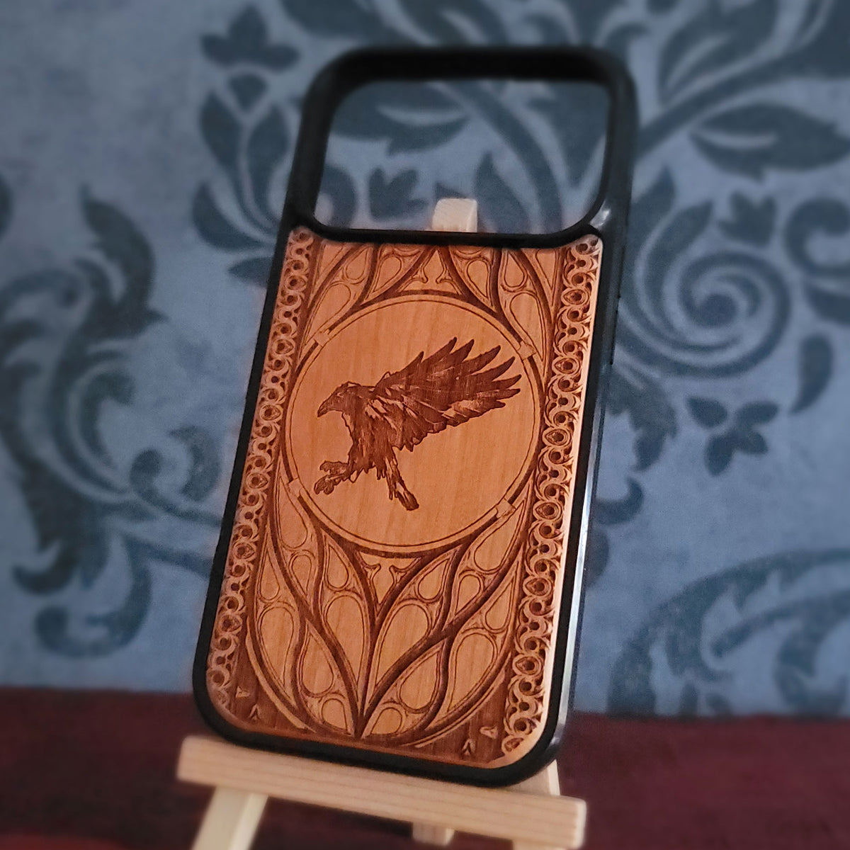 Gothic crow wood phone case with detailed bird engraving on natural cherrywood