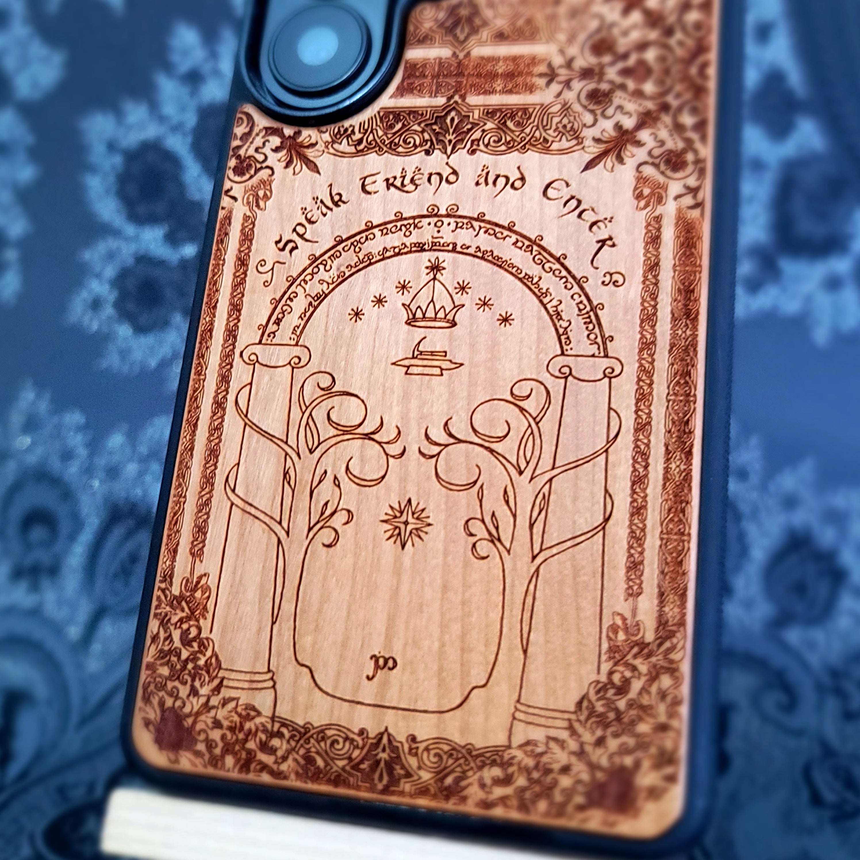 Deep laser engraved wooden phone case featuring a fantasy gate inspired by the Gates of Moria on natural wood for iPhone and Samsung Galaxy models.