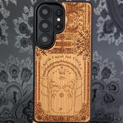 Deep laser engraved wooden phone case featuring a fantasy gate inspired by the Gates of Moria on natural wood for iPhone and Samsung Galaxy models.