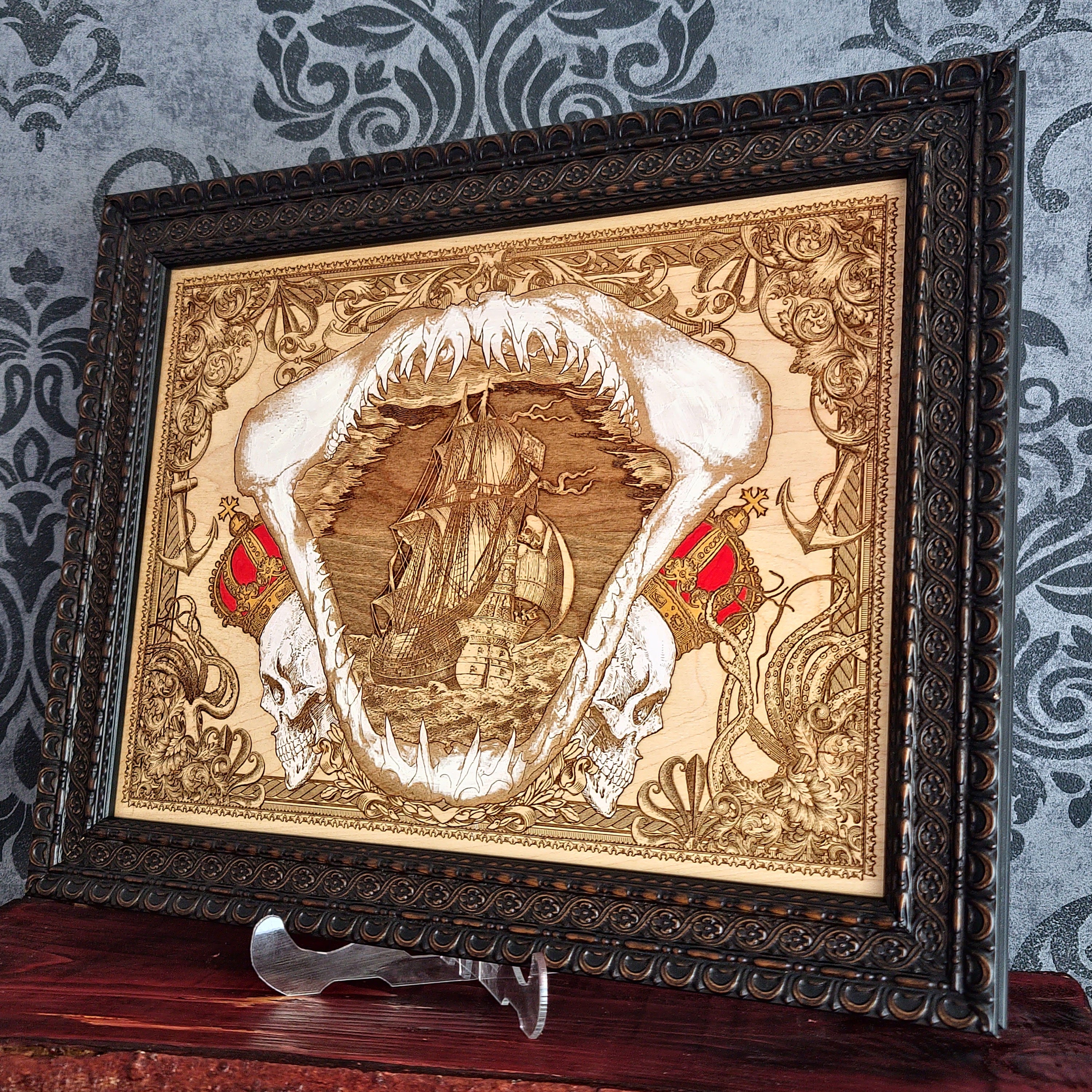 Large shark jaw and sailing ship wood wall art, angled view of the framed shark and sailing ship art