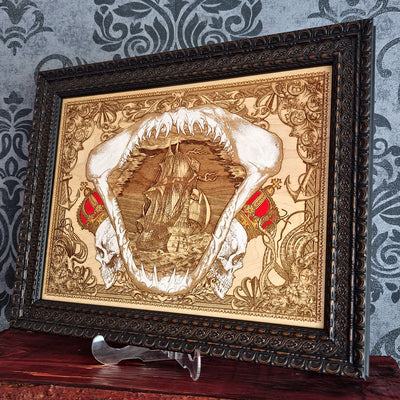 Large shark jaw and sailing ship wood wall art, angled view of the framed shark and sailing ship art