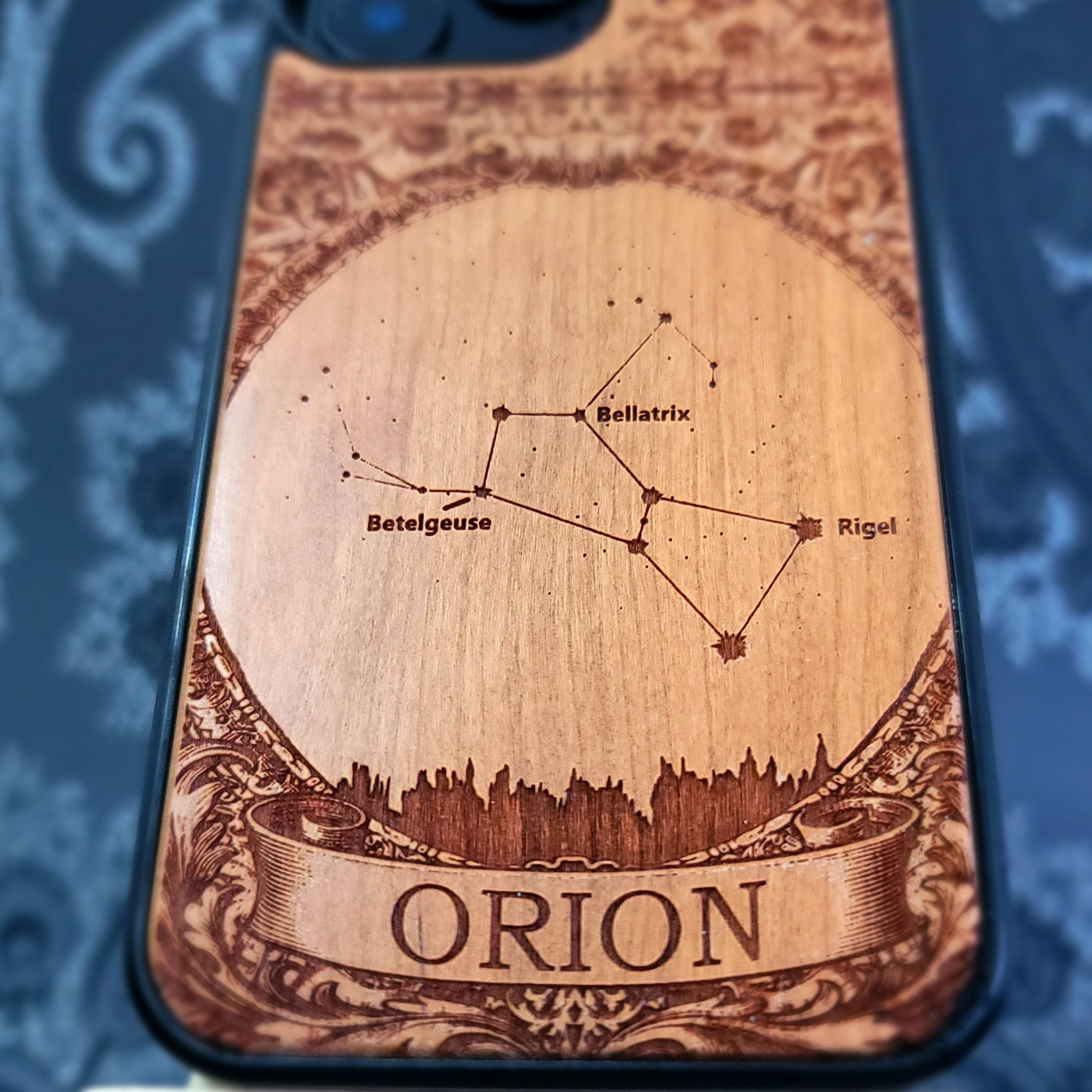 laser engraved wooden phone case featuring the Orion constellation with celestial star details on natural wood for iPhone and Samsung Galaxy models.