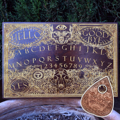 Gothic Ouija board wall art engraved on stained wood with gold-filled accents.