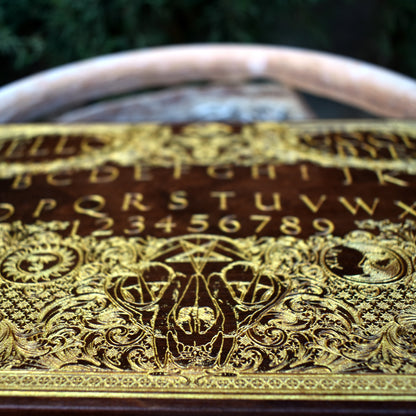 Laser-engraved wood Ouija board for gothic, spiritual, or Halloween displays.