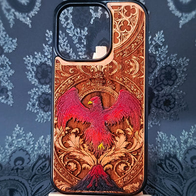 Deep laser engraved wooden phone case featuring a mythical phoenix bird with detailed flames and wings on natural wood for iPhone and Samsung Galaxy models.