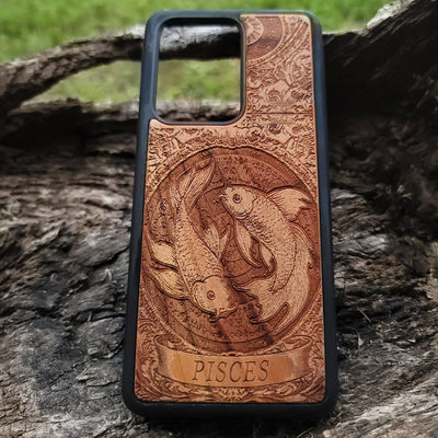 Pisces zodiac sign engraved on wood phone case with celestial art
