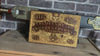 Occult-themed Ouija board artwork on wood with aged gold accents.