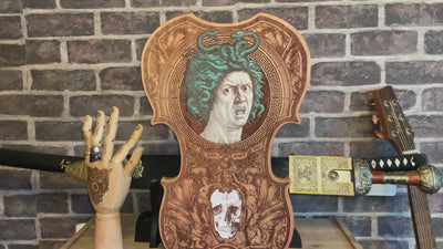 Hand-painted violin-shaped wood Medusa wall art, surreal home accent.