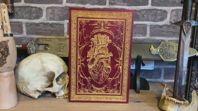 Laser-etched red heart on wood panel, perfect for gothic science-themed interiors.