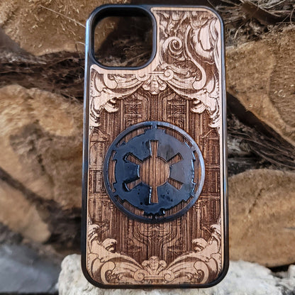 Wooden phone case with a detailed engraved sci-fi emblem resembling a galactic empire symbol, surrounded by ornate scrollwork, perfect for space opera fans