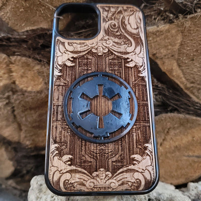 Wooden phone case with a detailed engraved sci-fi emblem resembling a galactic empire symbol, surrounded by ornate scrollwork, perfect for space opera fans