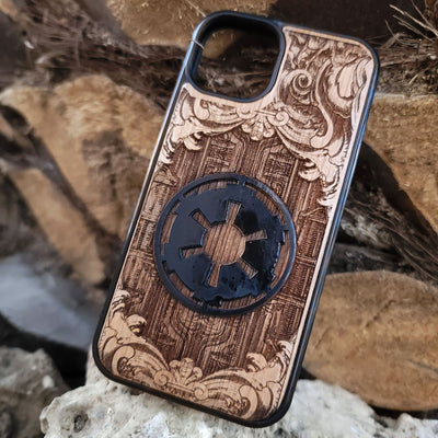 Wooden phone case with a detailed engraved sci-fi emblem resembling a galactic empire symbol, surrounded by ornate scrollwork, perfect for space opera fans
