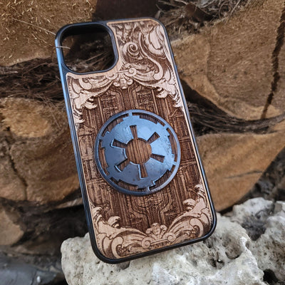 Wooden phone case with a detailed engraved sci-fi emblem resembling a galactic empire symbol, surrounded by ornate scrollwork, perfect for space opera fans