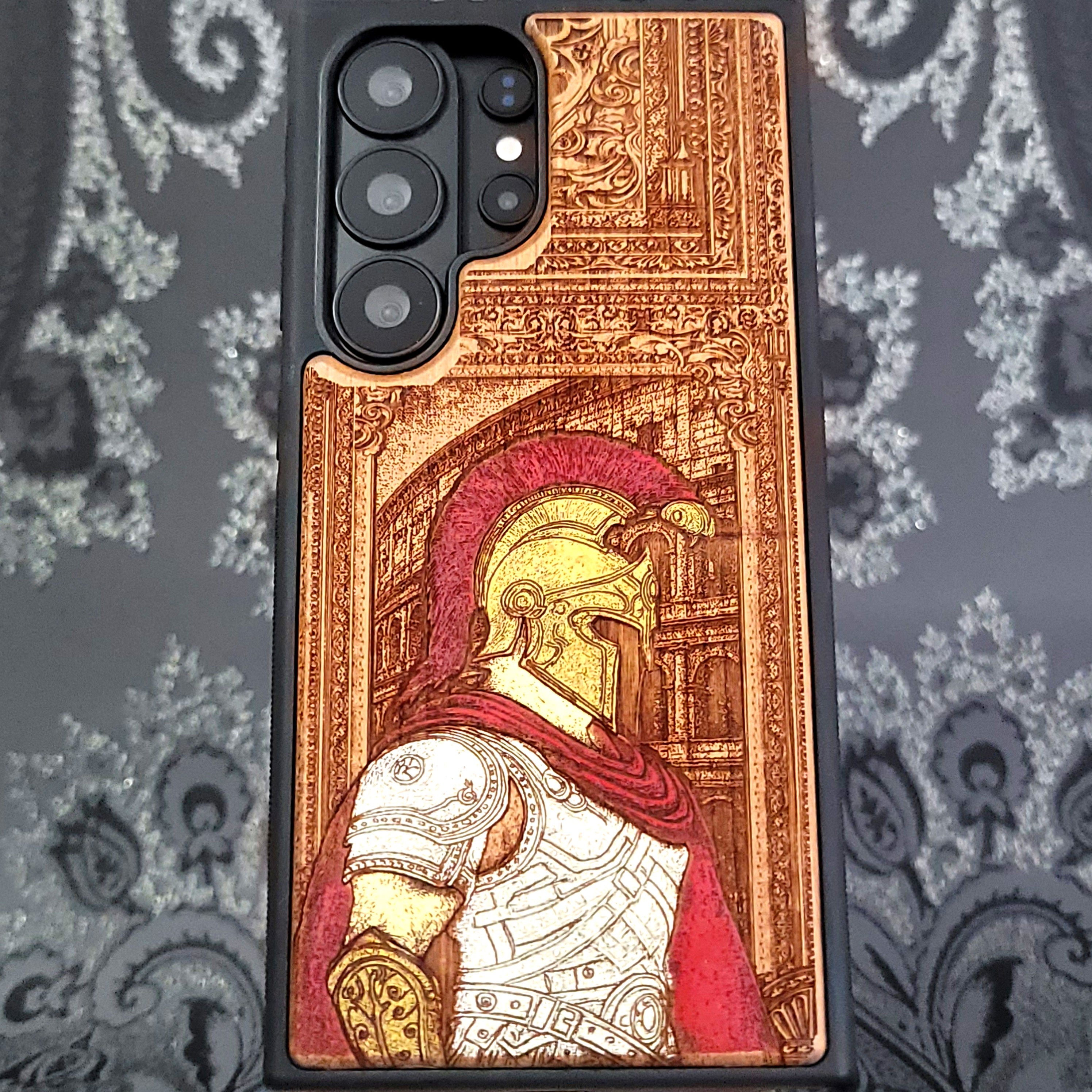 Deep laser engraved wooden phone case featuring a Roman centurion soldier in detailed legionnaire armor on natural wood for iPhone and Samsung Galaxy models.