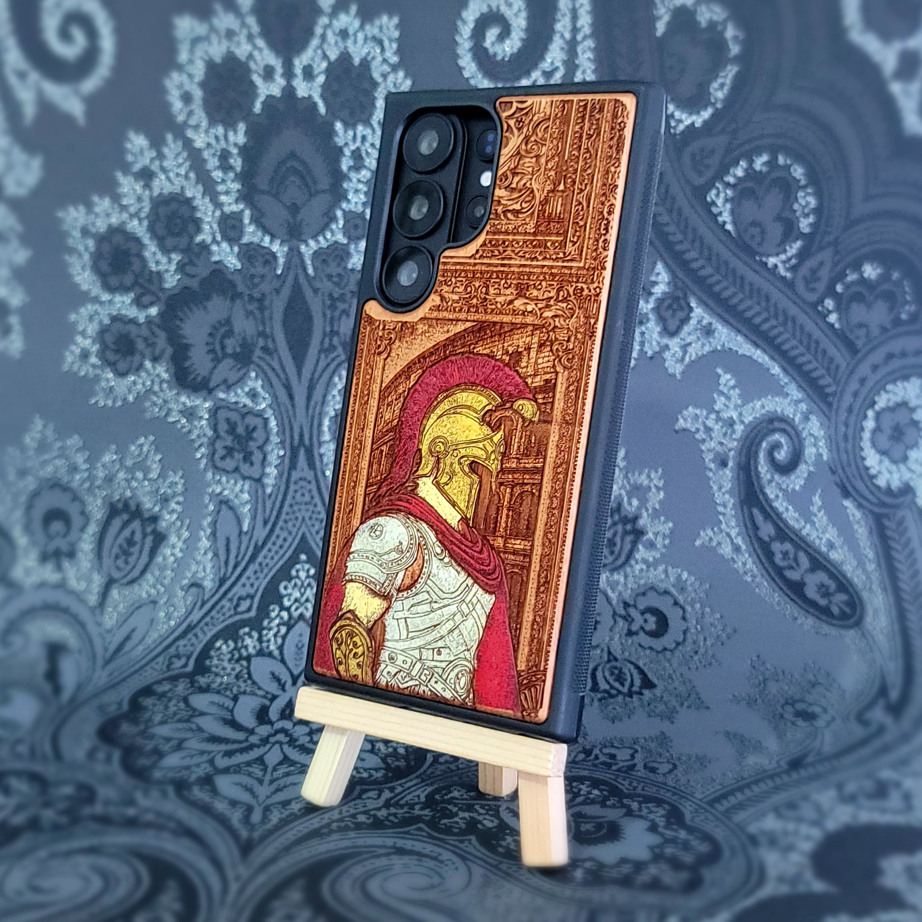 Deep laser engraved wooden phone case featuring a Roman centurion soldier in detailed legionnaire armor on natural wood for iPhone and Samsung Galaxy models.